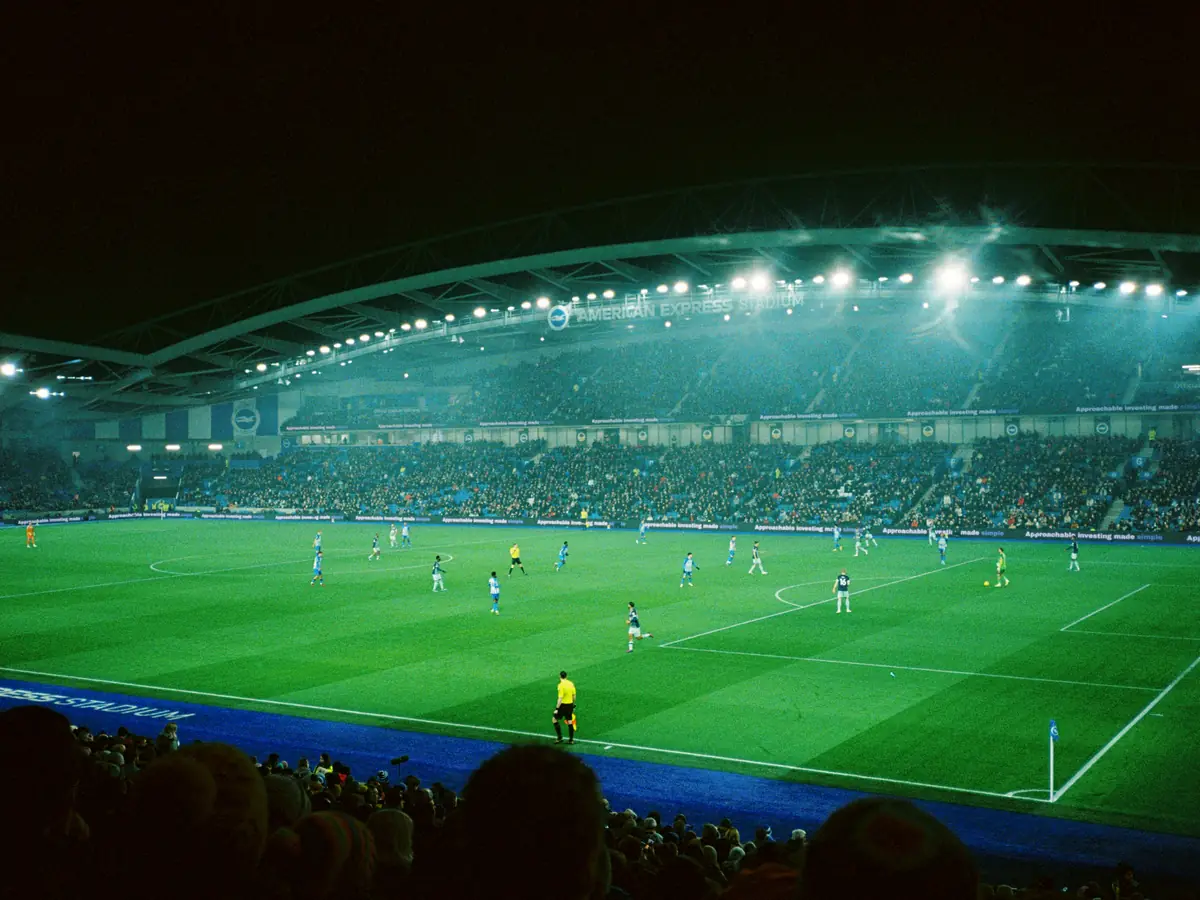 A floodlit football stadium at night
