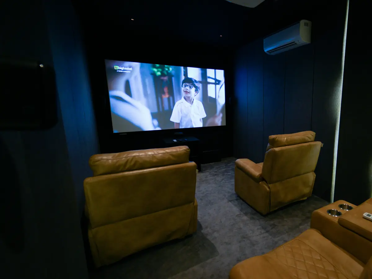 Home theatre recliners facing a big screen